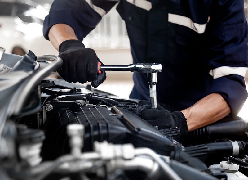 A service Expert working on a car
